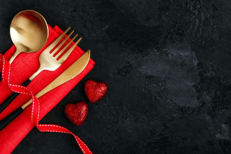 Valentine's Day table setting with red ribbon on darkの写真素材