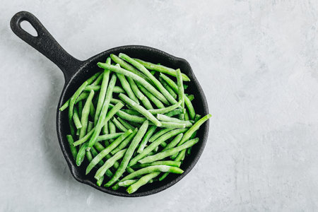 Frozen green beans in a pan ready for cooking. top view with copyspace.の写真素材