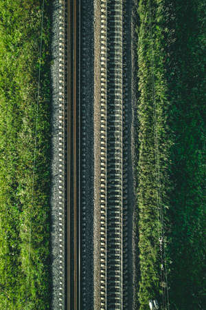 Aerial view of Railway railroad tracks through countryside in summerの写真素材