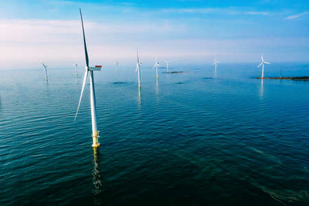 wind turbine. Aerial view of wind turbines or windmills farm field in blue sea in Finland....