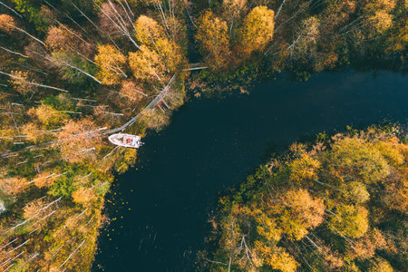 Aerial view of blue winding river and fall forest with autumn colorful trees. Beautiful nature...