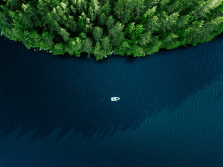 Aerial view fishing boat in blue lake and green woods in summer Finlandの写真素材