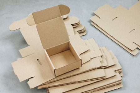 Paper Box. Brown paper box. Brown cardboard box on gray background, opened empty inside. Square...