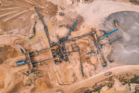 Aerial top view of open pit development and sand extraction. Mining industry reserves.