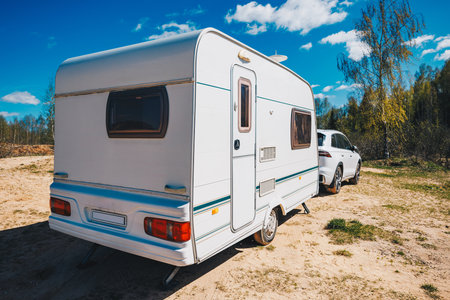 White trailer caravan car is parked on the side of the road. The scene is peaceful and quiet, ready to vacationの写真素材