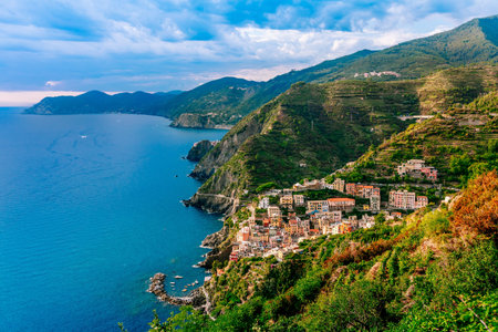 Scenic Coastal Village Overlooking Crystal Clear Waters and Lush Green Hillsides