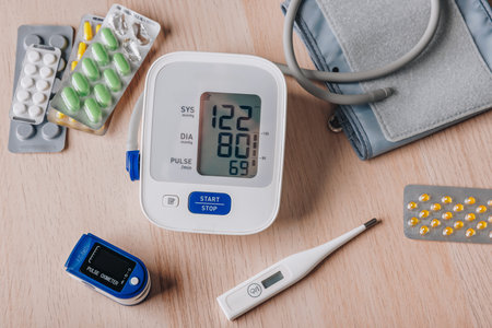 Blood Pressure Monitor, Pulse Oximeter, and Thermometer Surrounded by Medical Supplies