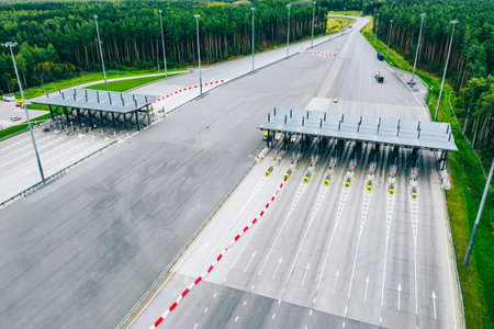 Aerial View of Toll Plaza with Multiple Lanes and Surrounding Forest Landscape