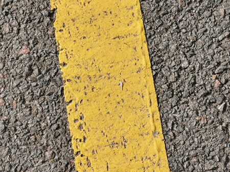 Texture of macadam asphalt with yellow line painted for design, background or wallpaper.