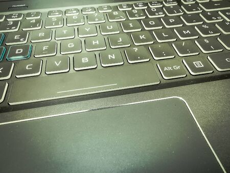 Modern laptop gaming keyboard with blue led backlight and touch pad