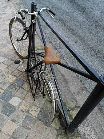 Bike chained with a lock, stolen wheelの写真素材