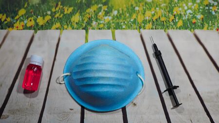 Coronavirus COVID-19 (2019-nCoV), epidemic, pandemic, quarantine, infectious disease concept, used soiled mask, syringe, medicine drugの写真素材