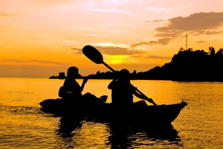 Silhouette of Two person kayaking in the sea at sunset in Koh Chang Thailandの写真素材