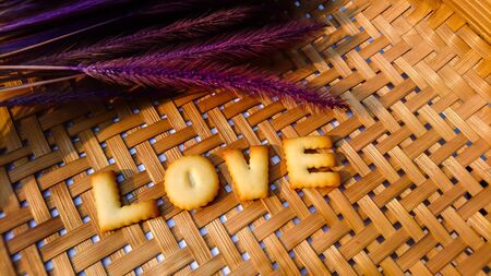 love alphabet word on brown wood backgroundの写真素材