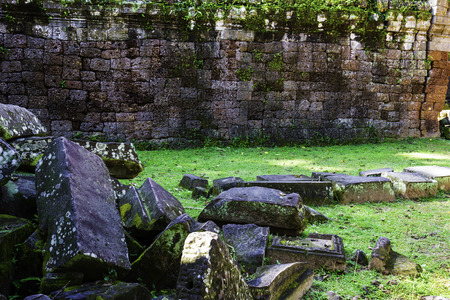 Ruin old brick wall on green grass, travel place in Cambodiaの写真素材