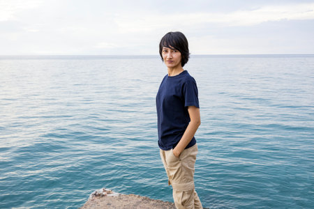 Asian Woman stand at sea near beach in Thailandの写真素材