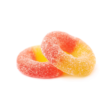 Torus shaped gelatin based sour sweet red and yellow colored chewing candy isolated over the white backgroundの写真素材