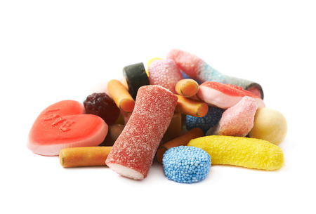 Pile of multiple different colorful candies isolated over the white backgroundの写真素材