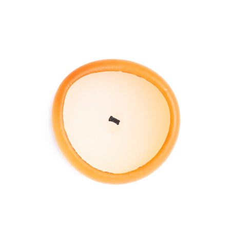 Burned orange candle isolated over the white background, top view aboveの写真素材
