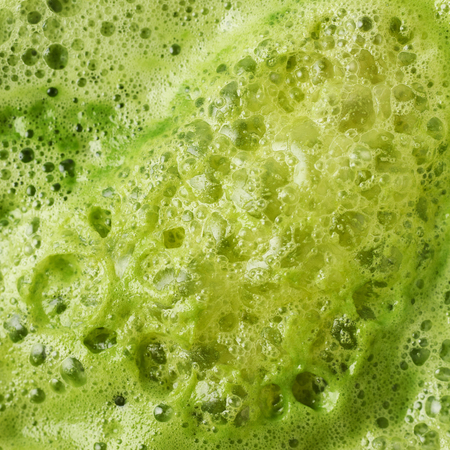 Green juice foam close-up shot as a background texture compositionの写真素材