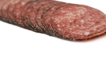 Stack of multiple salami sausage slices isolated over the white backgroundの写真素材