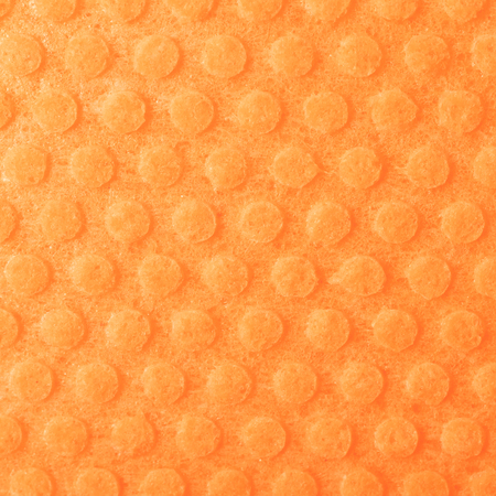 Orange kitchen wipe cloth close-up fragment as a background textureの写真素材