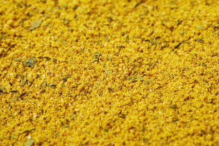 Surface covered with powdered yellow curry seasoning as a background texture compositionの写真素材