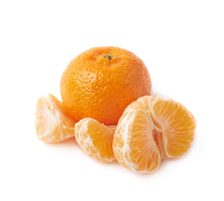 Whole tangerine fruit next to the peeled slices, composition isolated over the white backgroundの写真素材