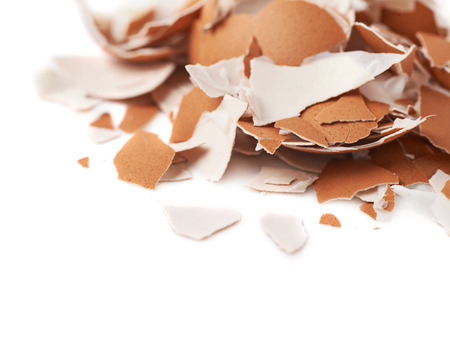 Pile of cracked egg shells isolated over the white background, close-up crop composition