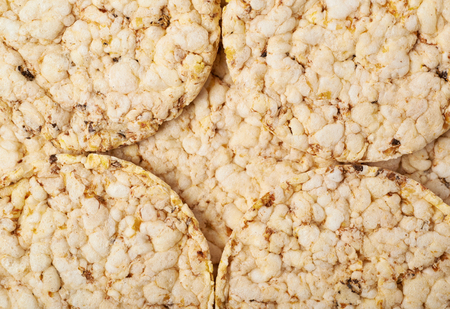 Surface covered with diet rice crackers as a close-up background composition