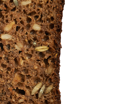 Black bread with seeds close-up fragment as a backdrop texture composition, slice's broder isolated...