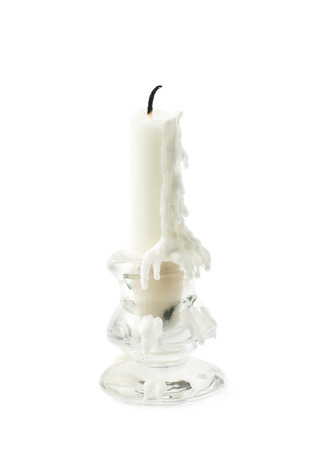 Burnt white candle in a candlestick, isolated over the white backgroundの写真素材