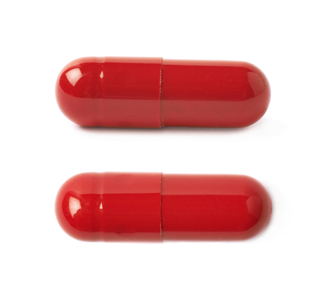 Macro shot of a red pill isolated over the white background, set of two different foreshorteningsの写真素材