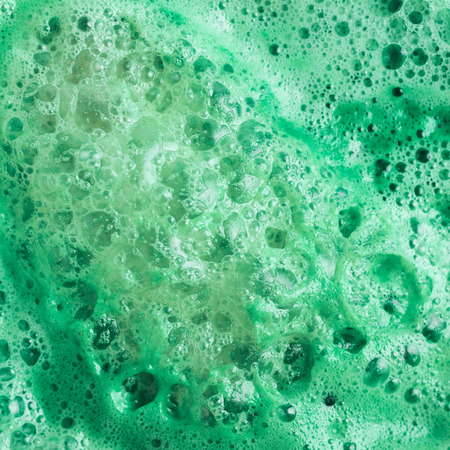 Green juice foam close-up shot as a background texture compositionの写真素材