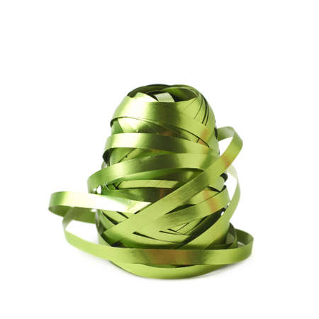 Glossy green ribbon reel partly unwrapped, composition isolated over the white backgroundの写真素材