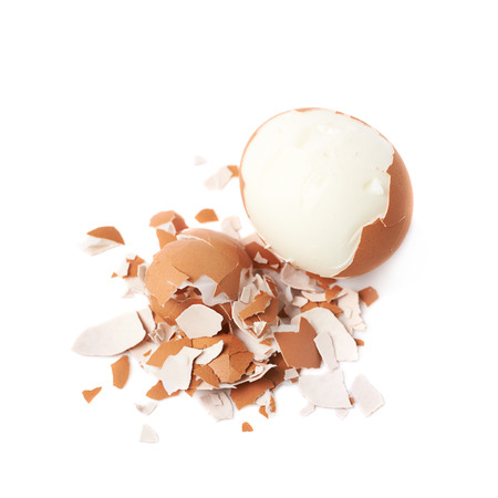 Cracked hard boiled egg isolated over the white background