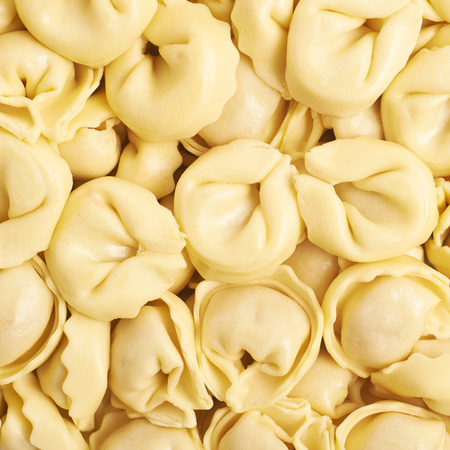 Surface covered with ravioli dumplings, close-up fragment crop as a backdrop compositionの写真素材