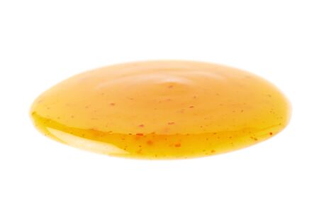 Round spill stain of sauce dressing isolated over the white backgroundの写真素材
