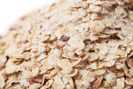 Pile of oatmeal groats porridge mixed with dried fruit pieces, close-up shallow depth of field composition as a backdropの写真素材