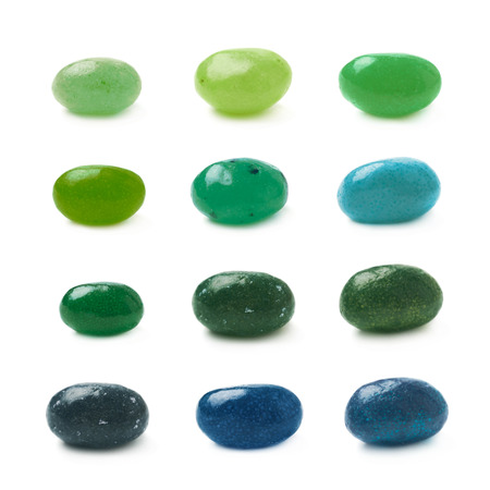 Single green jelly bean candy isolated over the white background, set of twelve different foreshorteningsの写真素材