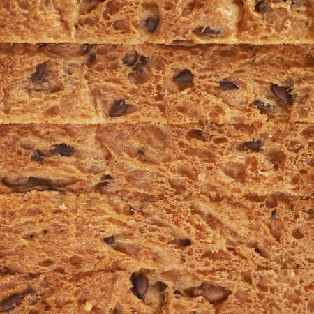 Sliced white bread loaf's crust texture close-up fragment