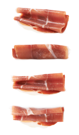 Folded prosciutto ham slice isolated over the white background, set of four different foreshorteningsの写真素材