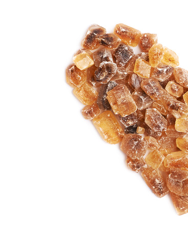 Heart shape made of large brown rock sugar crystals, composition isolated over the white backgroundの写真素材
