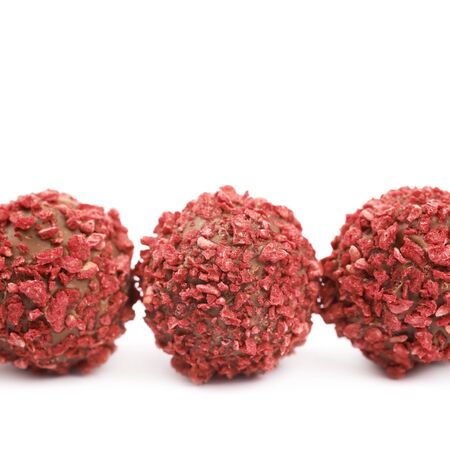 Line of handmade red candy balls, composition isolated over the white background, close-up crop fragmentの写真素材