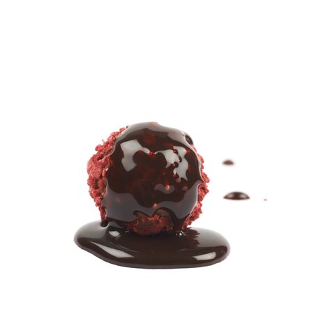 Single handmade red candy ball coated with the hot chocolate, composition isolated over the white backgroundの写真素材