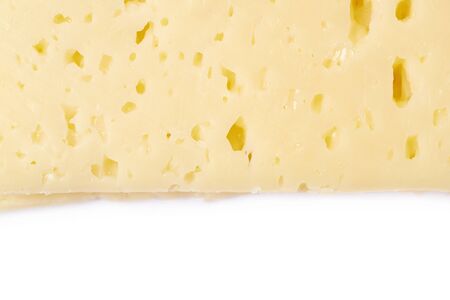 Close-up fragment of a cheese slice isolated over the white background as a backdrop compositionの写真素材
