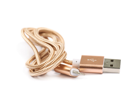 Folded USB lightning golden cable isolated over the white backgroundの写真素材