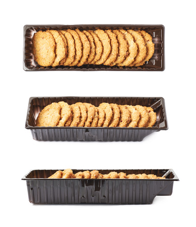 Plastic box filled with oatmeal thin cookies isolated over the white background, set of three different foreshorteningsの写真素材