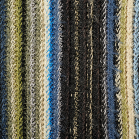 Fragment of a motley striped cloth fabric material texture as an abstract background composition