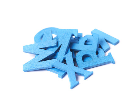 Pile of painted wooden letters isolated over the white backgroundの写真素材